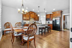 Dining area featuring a chandelier, light wood-type flooring, and recessed lighting