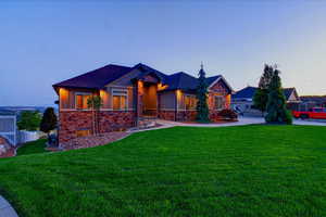 View of front of house featuring stone siding and board and batten siding