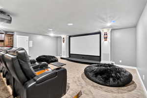 Home theater room featuring baseboards