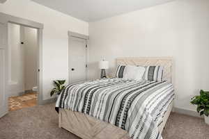 Bedroom with carpet and connected bathroom