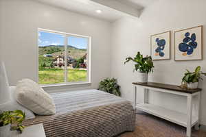 Carpeted bedroom with a mountain view