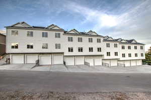 View of front facade featuring a garage and driveway