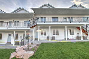View of front of home with a front lawn and a patio