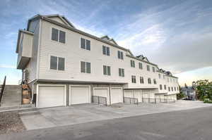 View of property with a garage and driveway
