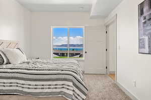 Bedroom featuring carpet and baseboards