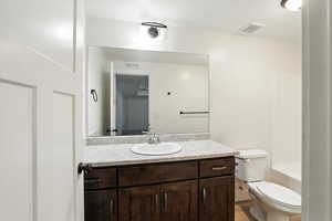 Full bathroom featuring vanity and toilet