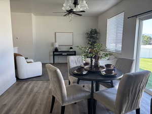 Dining area with wood finished floors and ceiling fan