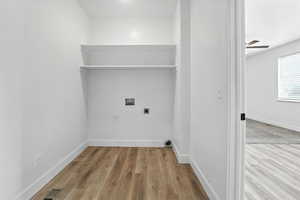 Laundry room with electric dryer hookup, washer hookup, wood finished floors, and a ceiling fan
