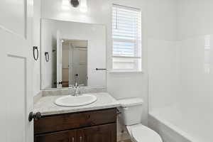 Bathroom featuring vanity and shower / tub combination