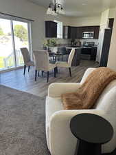 Dining room featuring a chandelier and dark wood-type flooring