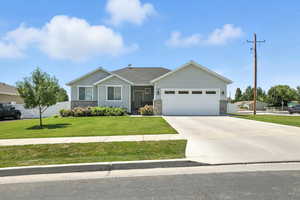 View of front of property featuring driveway, a garage, and board and batten siding