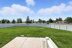 Fenced backyard featuring a patio