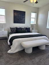 Bedroom with carpet floors, multiple windows, and ceiling fan