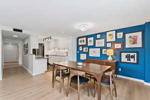 Dining room with light real hardwood floors.