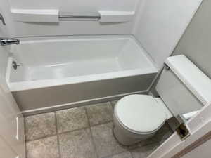 Full bathroom with tile patterned flooring and shower / tub combination