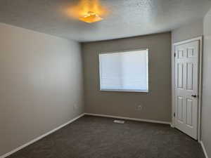 Bedroom featuring carpet and baseboards