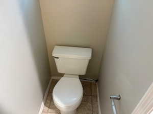 Half Bathroom featuring toilet and baseboards