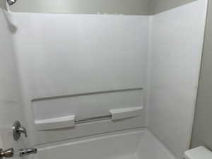 Full bathroom with shower / washtub combination and toilet