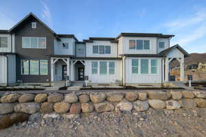 View of front facade with board and batten siding and a porch