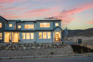 Rear view of property featuring board and batten siding and a mountain view