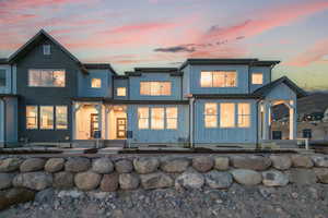 Back of property at dusk with board and batten siding