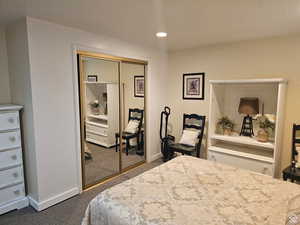 Carpeted bedroom featuring a closet and recessed lighting