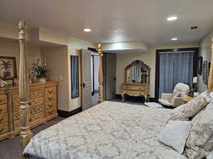 Bedroom featuring dark colored carpet and recessed lighting