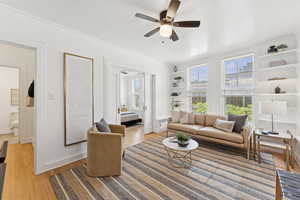 Living room featuring ceiling fan and light wood finished floors