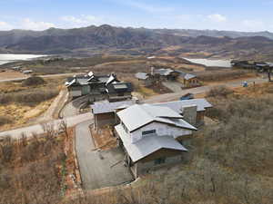 Aerial view of property and surrounding area with a water and mountain view