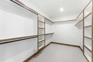 Walk in closet featuring light carpet