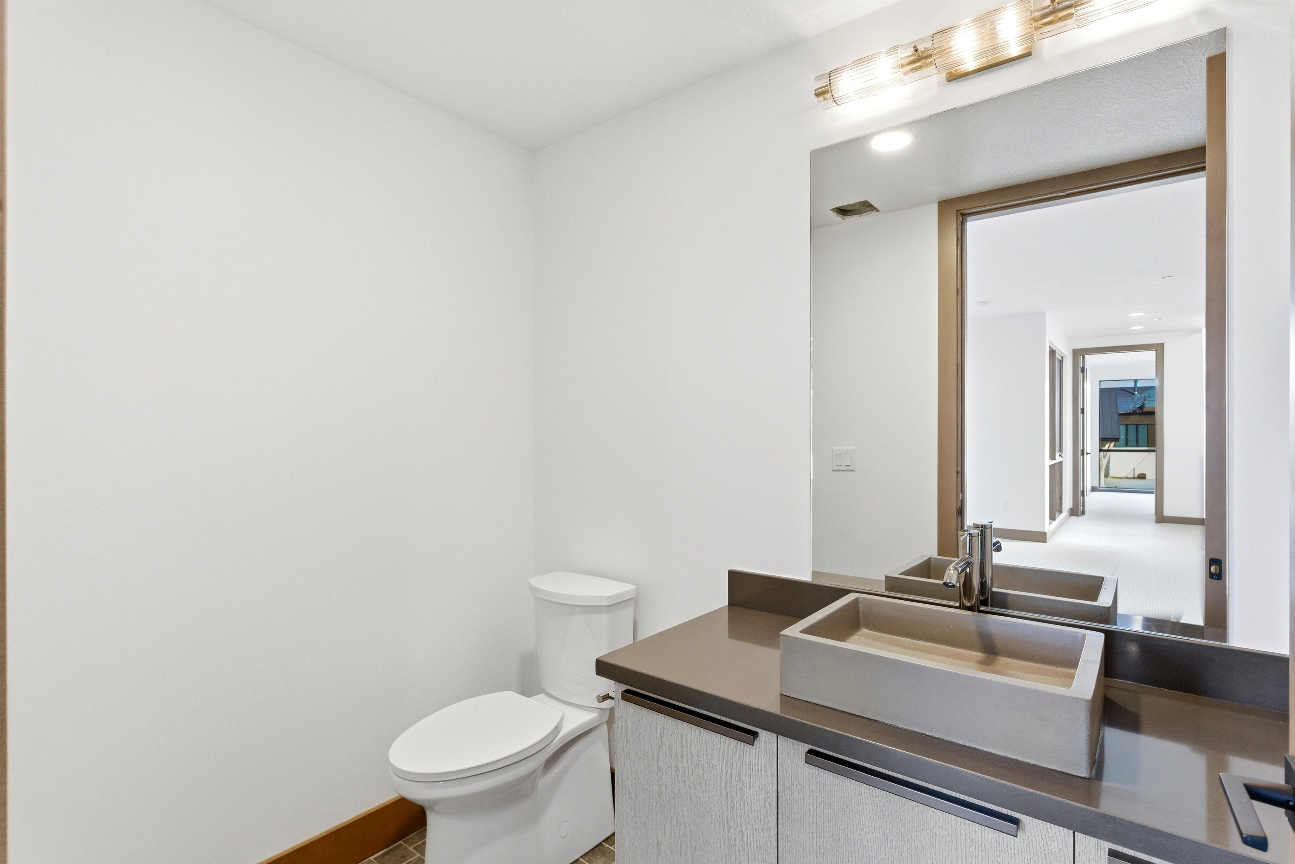 Half bath featuring toilet and vanity