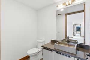 Half bath featuring toilet and vanity