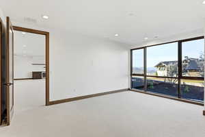 Unfurnished room with light carpet and recessed lighting