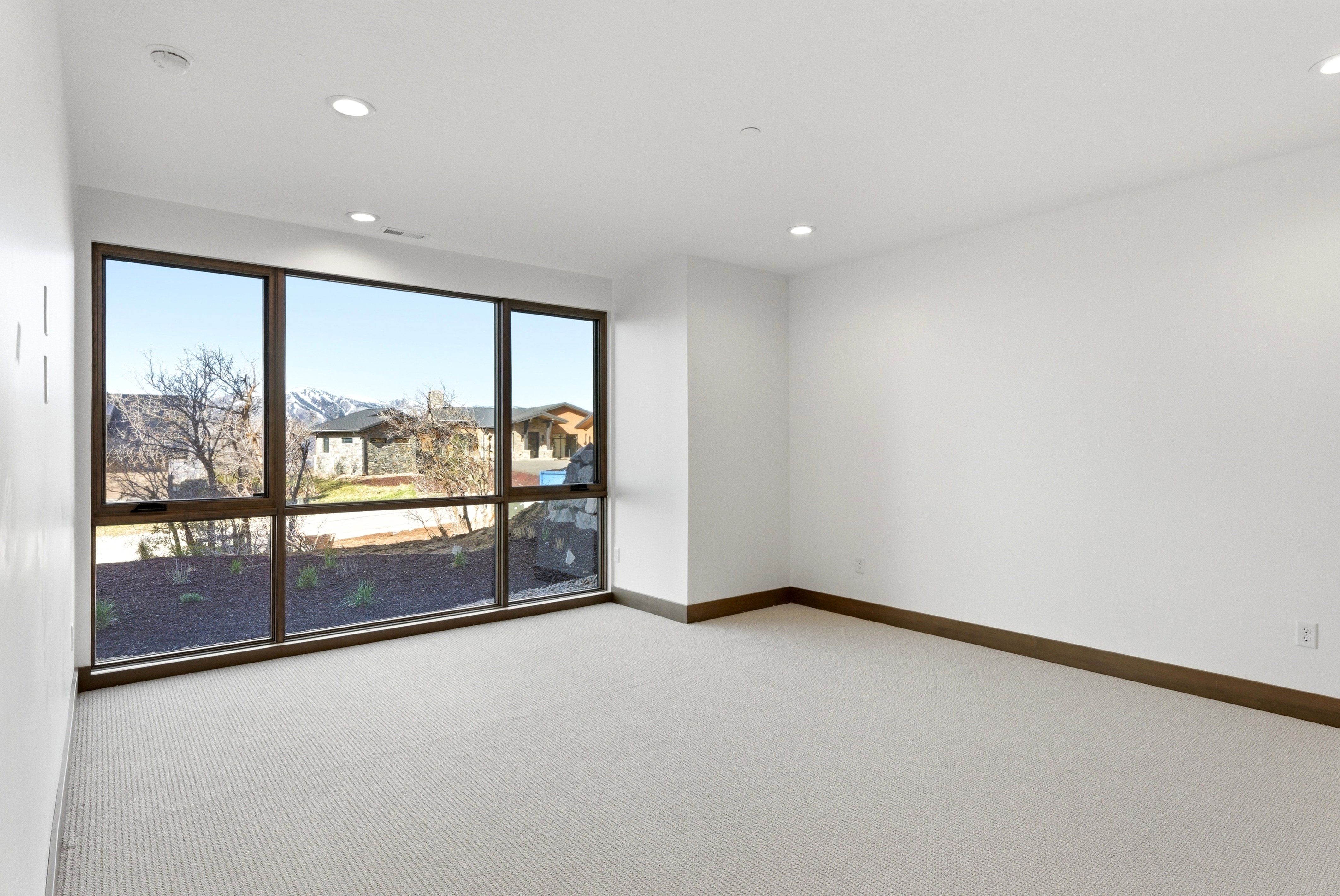 Spare room with light carpet and recessed lighting