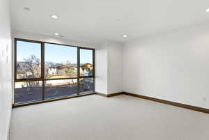 Spare room with light carpet and recessed lighting
