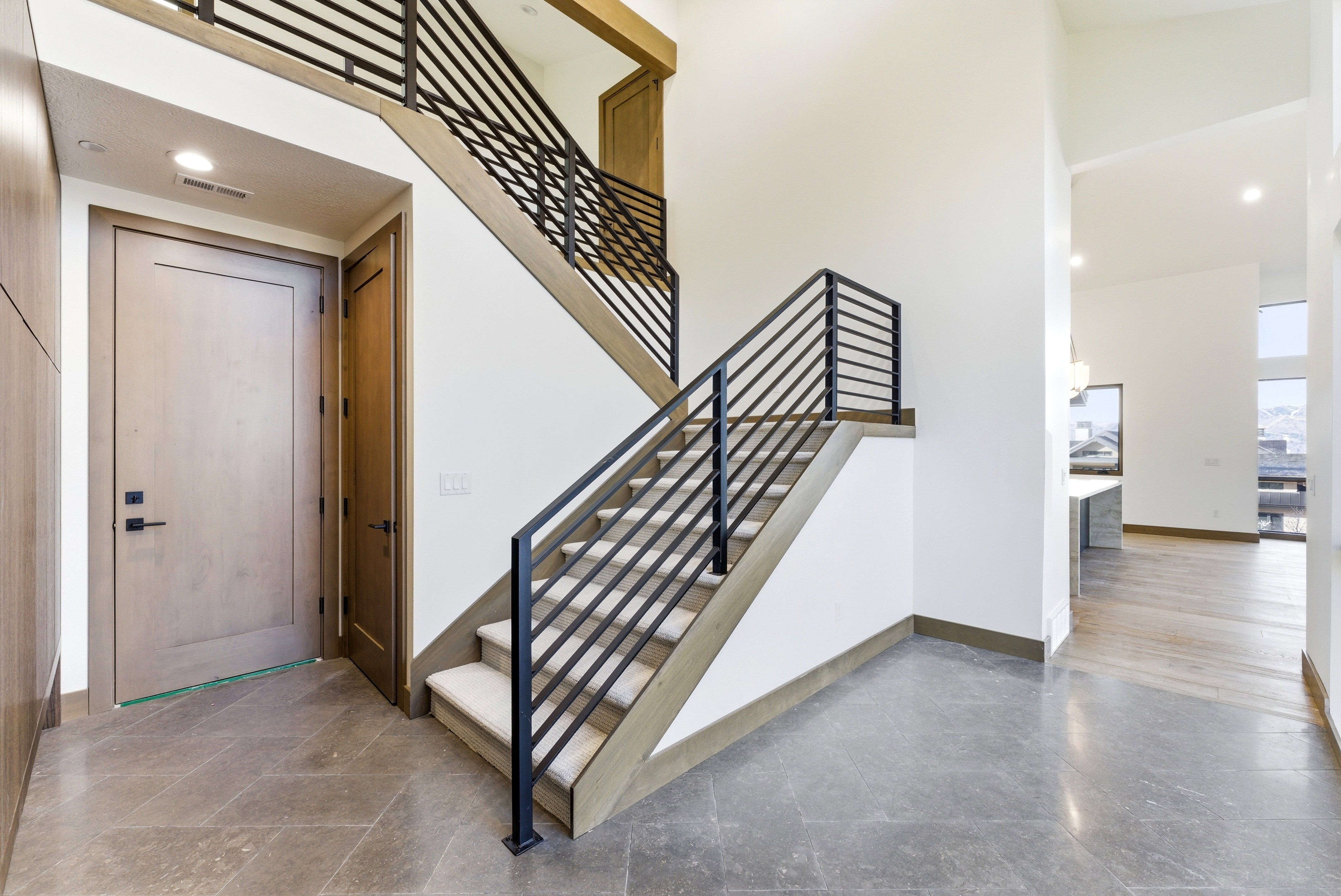 Staircase featuring recessed lighting and a high ceiling