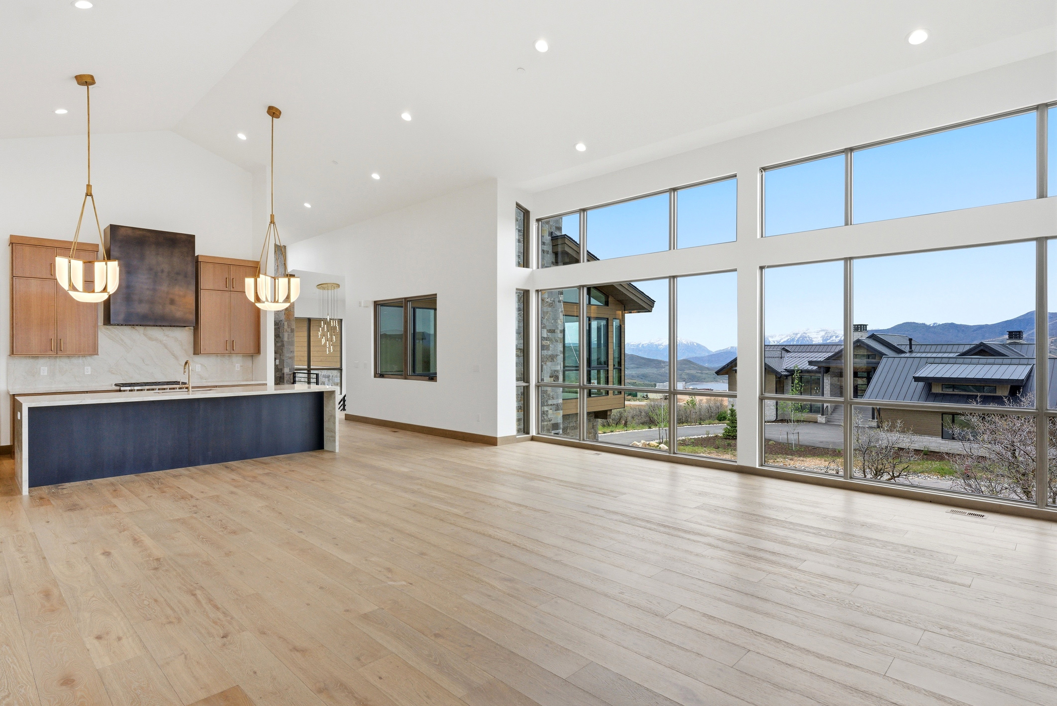 Expansive living area with high ceilings and wood-finish flooring