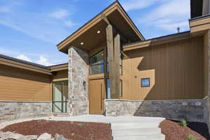Entrance to property with stone siding