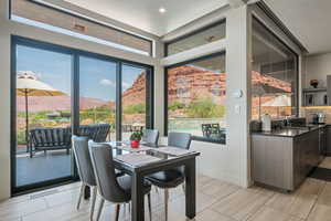 Dining area featuring a mountain view and plenty of natural light