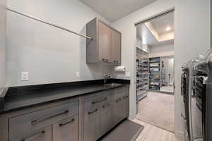 Kitchen with dark countertops, gray cabinets, and a tray ceiling