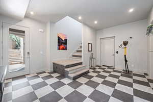 Foyer featuring stairway and recessed lighting