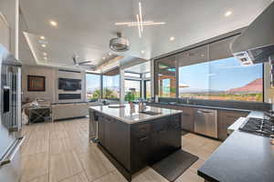 Kitchen with extractor fan, appliances with stainless steel finishes, a ceiling fan, healthy amount of natural light, and recessed lighting