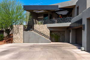 Contemporary house featuring stucco siding, a garage, and driveway