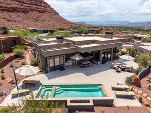 Outdoor pool featuring a mountain view and a patio area