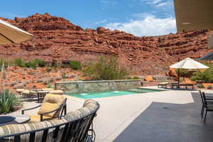 Swimming pool with a patio and a mountain view