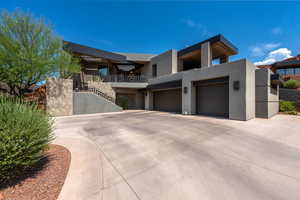 Contemporary house with stucco siding, concrete driveway, and a garage