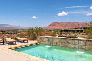 Outdoor pool featuring a mountain view