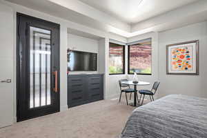 Bedroom featuring carpet floors and baseboards