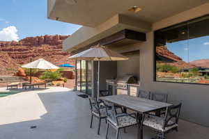 View of patio / terrace with outdoor dining space, area for grilling, and a mountain view