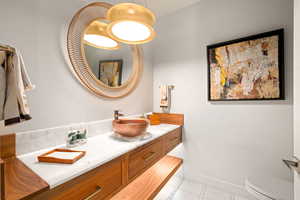 Bathroom featuring tile patterned flooring and vanity
